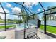 Relax in this screened-in hot tub, featuring a lake view, set in a backyard tropical oasis with swaying palm trees at 5319 120Th E Ave, Parrish, FL 34219