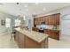 Modern kitchen features granite countertops, stainless steel appliances, breakfast bar, and wooden cabinets at 5319 120Th E Ave, Parrish, FL 34219