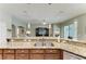 Kitchen island with stainless sink, granite countertops and a view of the living room and dining area at 5319 120Th E Ave, Parrish, FL 34219