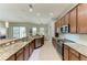 Open kitchen features granite counters, stainless appliances, tile floors, and a breakfast bar overlooking the living area at 5319 120Th E Ave, Parrish, FL 34219