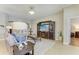 Living room with neutral tones, large TV, and an archway leading to other parts of the house at 5319 120Th E Ave, Parrish, FL 34219