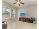 Cozy living room featuring tile floors, a ceiling fan, and a large window offering ample natural light and a TV at 5319 120Th E Ave, Parrish, FL 34219