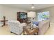 Bright living room features a large TV, comfortable seating, and access to the outdoor patio at 5319 120Th E Ave, Parrish, FL 34219