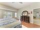 Bright main bedroom features wood floors, bay window, dresser, and decorative wall accents at 5319 120Th E Ave, Parrish, FL 34219