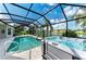 Enjoy this screened-in pool and hot tub, overlooking a serene lake and lush landscaping with plenty of privacy at 5319 120Th E Ave, Parrish, FL 34219