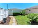 The cozy backyard has a stone path, a small tree, and a white fence at 5420 River Sound Ter, Bradenton, FL 34208