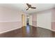 A lovely bedroom has wood-look floors, base molding, neutral wall paint, and a ceiling fan with lights at 5420 River Sound Ter, Bradenton, FL 34208