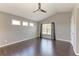 Bedroom featuring a high ceiling, three windows, and hardwood floors at 5420 River Sound Ter, Bradenton, FL 34208
