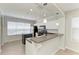 Bright kitchen features white cabinets, stainless steel appliances, and a breakfast bar overlooking the dining area at 5420 River Sound Ter, Bradenton, FL 34208