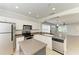 Bright kitchen features white cabinets, stainless steel appliances, and an island that provides extra counter space at 5420 River Sound Ter, Bradenton, FL 34208