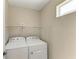 Efficient laundry room with washer, dryer, and shelving at 5420 River Sound Ter, Bradenton, FL 34208