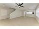 Open-concept living room featuring tile floors and a ceiling fan at 5420 River Sound Ter, Bradenton, FL 34208