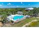Stunning community pool area with ample seating, a covered gazebo, and lush tropical landscaping at 5420 River Sound Ter, Bradenton, FL 34208