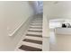 Staircase with painted risers and wood treads at 5420 River Sound Ter, Bradenton, FL 34208