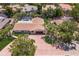Aerial view of the home with a well-maintained lawn, pool, and lush landscaping at 5581 Shadow Lawn Dr, Sarasota, FL 34242