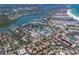 An aerial view highlights a coastal community with a marina, residences, and easy access to the beach at 5581 Shadow Lawn Dr, Sarasota, FL 34242