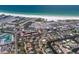 A scenic aerial view of a coastal community with a mix of housing, tennis courts, and beach access at 5581 Shadow Lawn Dr, Sarasota, FL 34242