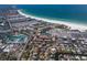 Overhead view showcasing a coastal community with beachfront condos and charming residential homes near the ocean at 5581 Shadow Lawn Dr, Sarasota, FL 34242