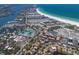 Aerial view shows beach condos and waterfront homes with docks, tennis courts, and roads at 5581 Shadow Lawn Dr, Sarasota, FL 34242