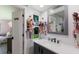 Charming bathroom featuring a dark vanity, white countertop and organized accessories at 5581 Shadow Lawn Dr, Sarasota, FL 34242