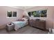Charming bedroom with pink walls, a chandelier, a bed with plush toys, and natural light at 5581 Shadow Lawn Dr, Sarasota, FL 34242