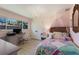 Cozy bedroom showcasing a decorative chandelier, a writing desk and a bed with a colorful quilt at 5581 Shadow Lawn Dr, Sarasota, FL 34242