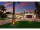 Beautifully landscaped home with a brick driveway and a lush green lawn at sunset at 5581 Shadow Lawn Dr, Sarasota, FL 34242