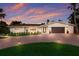 Charming single-story home with brick driveway, manicured lawn, and a two-car garage, perfect for modern living at 5581 Shadow Lawn Dr, Sarasota, FL 34242