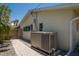Side view of the home featuring a brick walkway, a large generator, and a well-maintained exterior at 5581 Shadow Lawn Dr, Sarasota, FL 34242