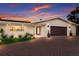 Stylish home with a brick driveway and well-maintained landscaping at dusk at 5581 Shadow Lawn Dr, Sarasota, FL 34242