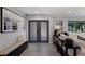 Inviting foyer with neutral tones, featuring stylish decor, tile flooring, and double front doors at 5581 Shadow Lawn Dr, Sarasota, FL 34242