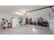 Well-lit garage featuring storage shelves, bicycle racks, and ample space for parking and organization at 5581 Shadow Lawn Dr, Sarasota, FL 34242