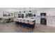 Modern kitchen featuring a large island with seating, stainless steel appliances, and a dining area at 5581 Shadow Lawn Dr, Sarasota, FL 34242