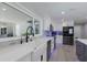 Well-equipped kitchen with modern appliances, a farmhouse sink, and a view to the outdoor pool at 5581 Shadow Lawn Dr, Sarasota, FL 34242