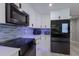 Bright kitchen with white cabinets, stainless steel appliances, and modern backsplash at 5581 Shadow Lawn Dr, Sarasota, FL 34242