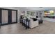 Modern living room features sleek design, a large sofa, and an entertainment center with a linear fireplace at 5581 Shadow Lawn Dr, Sarasota, FL 34242