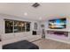Bright living room features a modern fireplace, recessed lighting, and a large sectional sofa, perfect for relaxing or entertaining at 5581 Shadow Lawn Dr, Sarasota, FL 34242