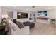 Bright living room features a modern fireplace, recessed lighting, and a large sectional sofa, perfect for relaxing or entertaining at 5581 Shadow Lawn Dr, Sarasota, FL 34242