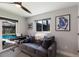 Relaxing living room showing a comfortable gray sofa and a view of the refreshing pool area at 5581 Shadow Lawn Dr, Sarasota, FL 34242