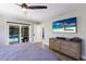 Main bedroom featuring backyard views, a ceiling fan, and access to the pool area at 5581 Shadow Lawn Dr, Sarasota, FL 34242