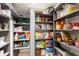 Well-organized pantry with shelves stocked with various food items and kitchen supplies at 5581 Shadow Lawn Dr, Sarasota, FL 34242