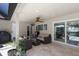 The covered outdoor patio area offers a relaxing seating area with a ceiling fan and serene views of the pool at 5581 Shadow Lawn Dr, Sarasota, FL 34242