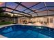 A large screened pool is accessible to multiple doors and an outdoor living area for seamless indoor/outdoor living at 5581 Shadow Lawn Dr, Sarasota, FL 34242