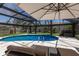 Screened-in pool area featuring a bright pool, lounge chairs, and a well-maintained patio at 5581 Shadow Lawn Dr, Sarasota, FL 34242