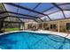Enjoy the private backyard oasis with a sparkling pool, lounge chairs, and a screened-in lanai for entertaining at 5581 Shadow Lawn Dr, Sarasota, FL 34242