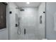 Modern shower featuring black fixtures, a glass door, and tiled walls at 5581 Shadow Lawn Dr, Sarasota, FL 34242