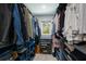 Walk-in closet with wood flooring and custom shelving offering ample storage at 5581 Shadow Lawn Dr, Sarasota, FL 34242