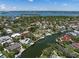 Aerial view of a waterfront community with private docks and lush tropical landscaping at 572 Commonwealth Ln, Sarasota, FL 34242