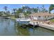 Waterfront home featuring a private boat dock, fire pit, and screened-in lanai at 572 Commonwealth Ln, Sarasota, FL 34242