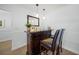 Well-appointed home bar with comfortable seating, ideal for entertaining and enjoying your favorite beverages at 572 Commonwealth Ln, Sarasota, FL 34242